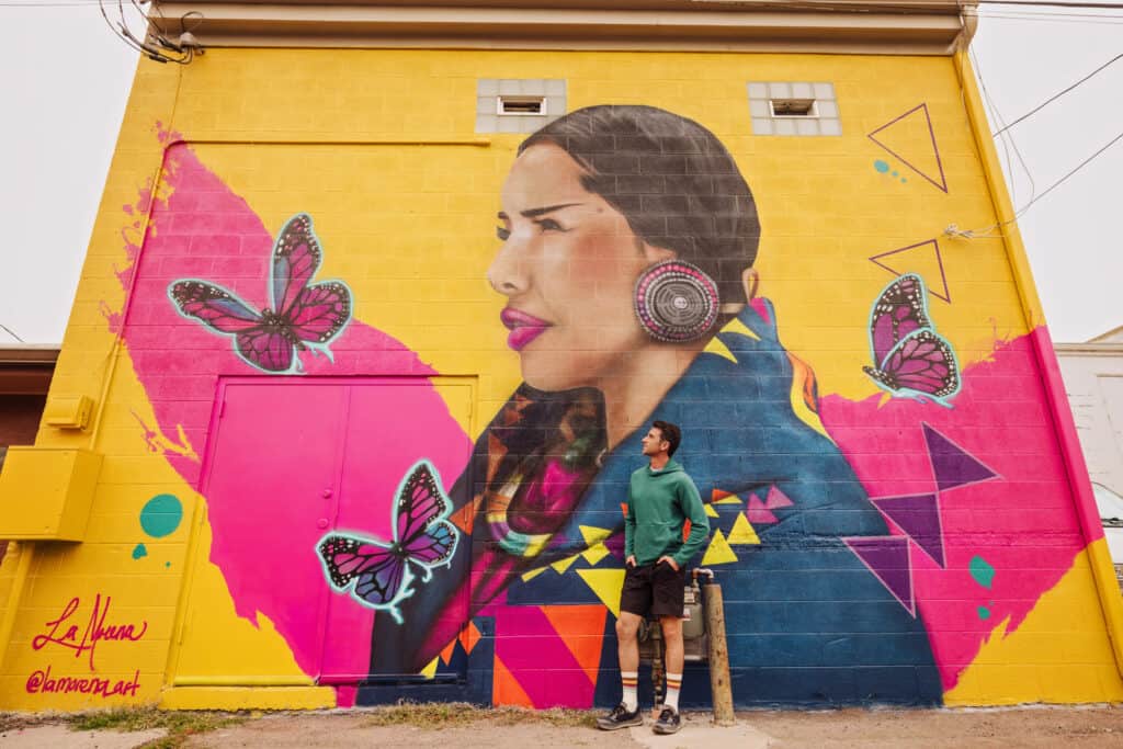 Jared Dillingham in front of an ArtsFest Mural