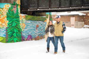 Couple walks along the snowy River's Edge Trail in Great Falls, Montana
